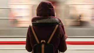 person standing in front of passing train