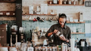 Barista pouring latte