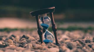 hourglass buried in rocks