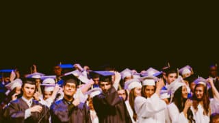 college graduates moving tassels on caps
