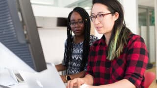 Two women working at computers