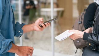 Person scanning a document with a smartphone