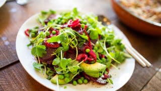 Salad of arugula, avocados, and beets on a plate