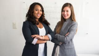 Two businesswomen in front of presentation