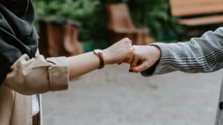 Two hands fist bumping