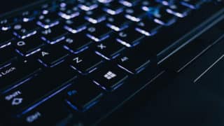Backlit black keyboard focusing on Windows button