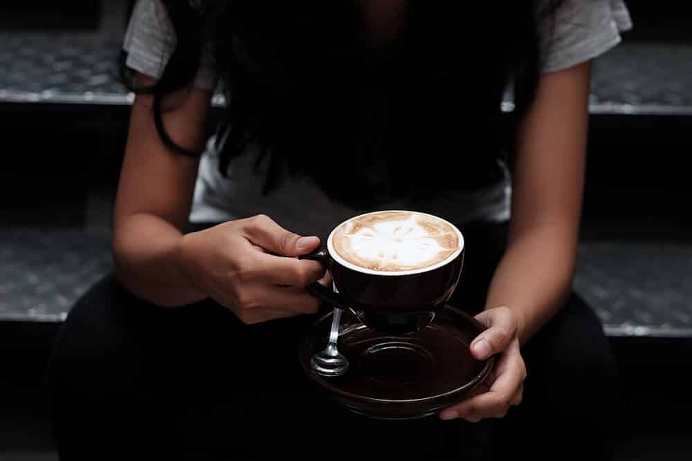 Girl sitting with a latte