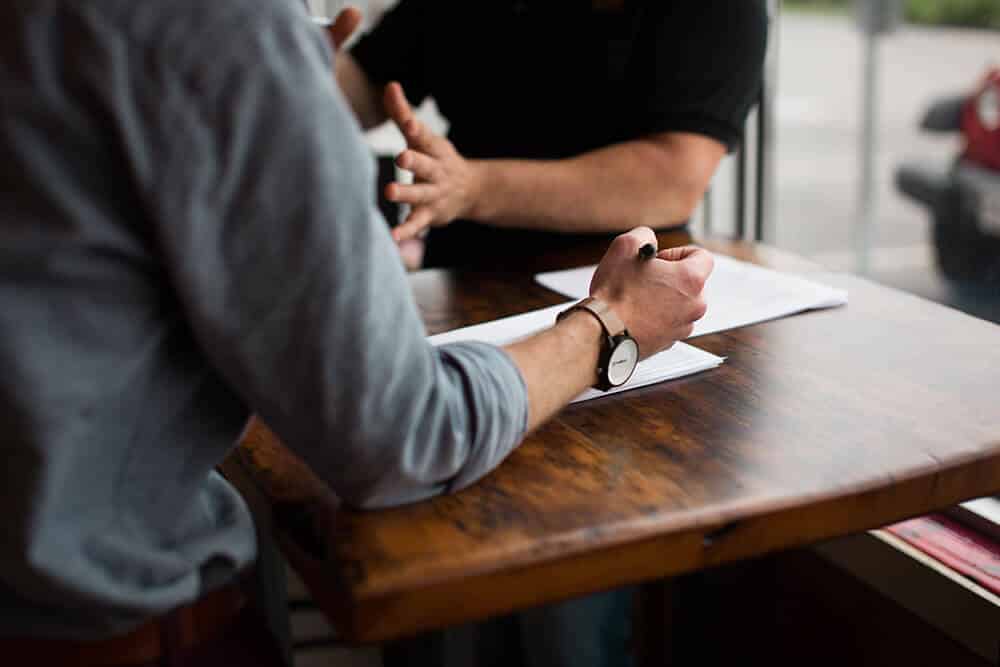 person taking notes in an interview