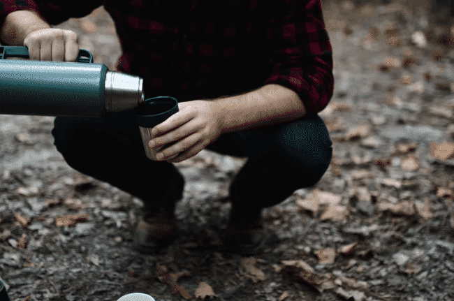 Man Pouring from Stanley Thermos