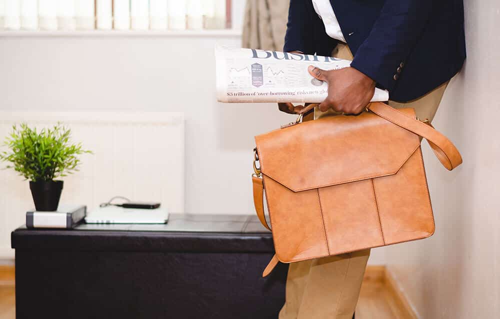 man with newspaper and briefcase