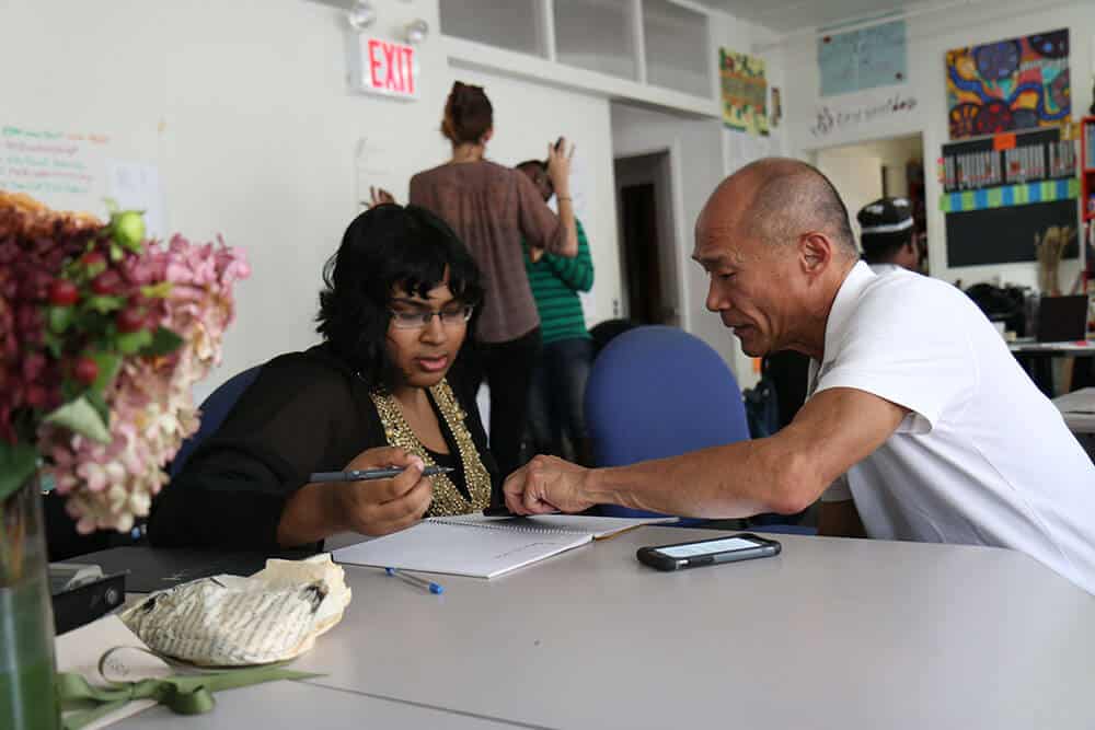 mentor helping student at table