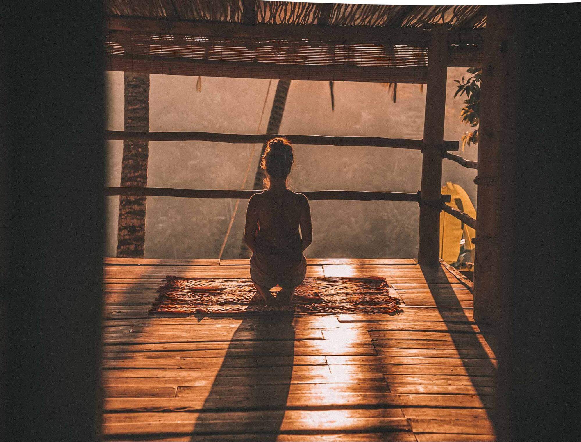 woman meditating at dawn