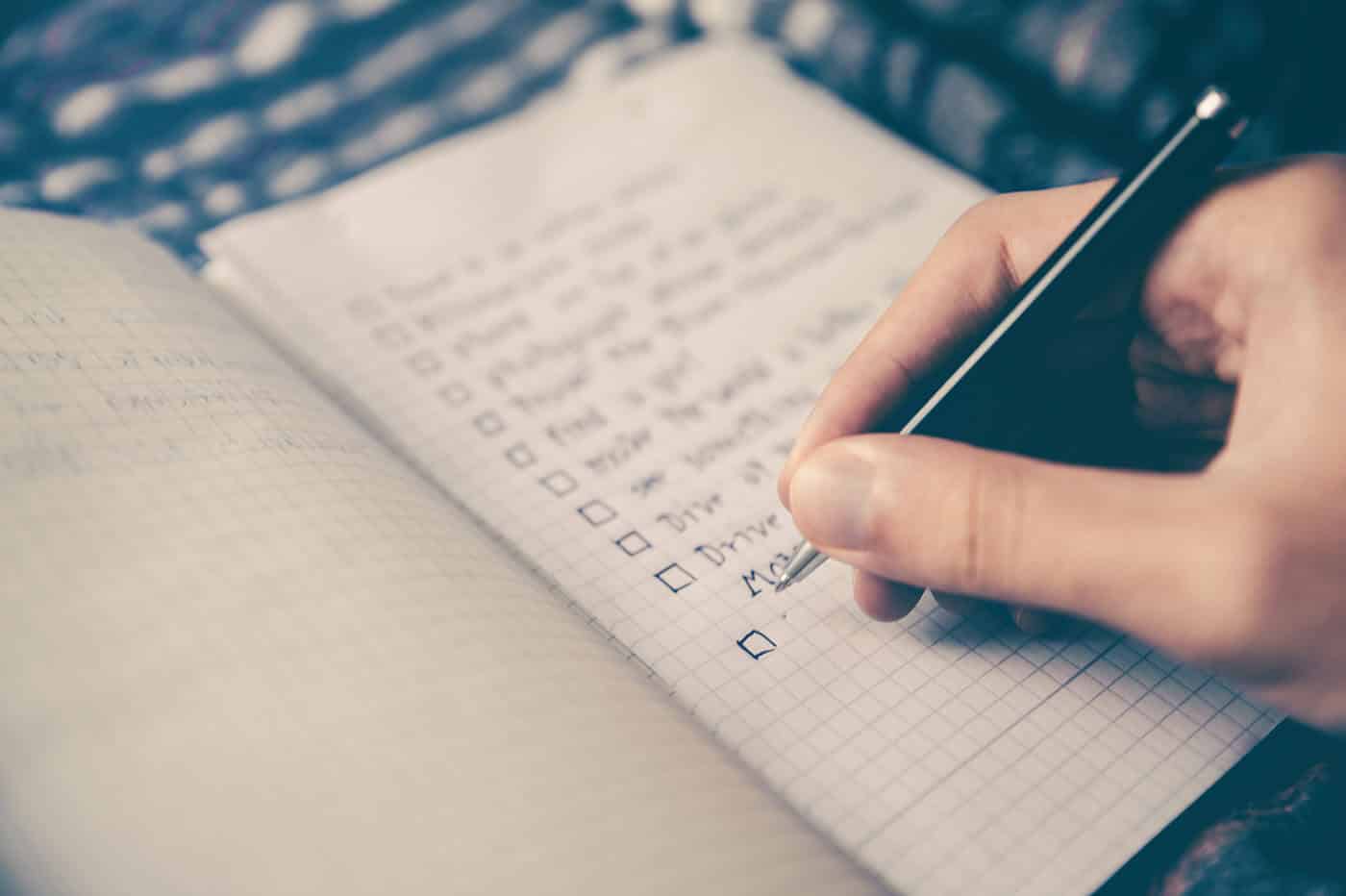writing a checklist in a notebook