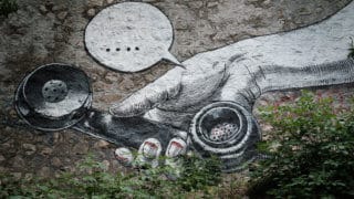 mural of hand holding phone with speech bubble