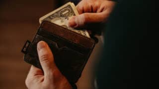 pulling dollar bill out of wallet