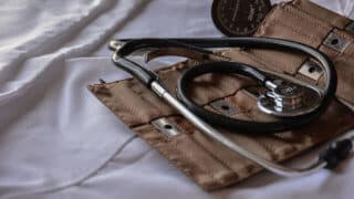 Stethoscope on top of brown leather case