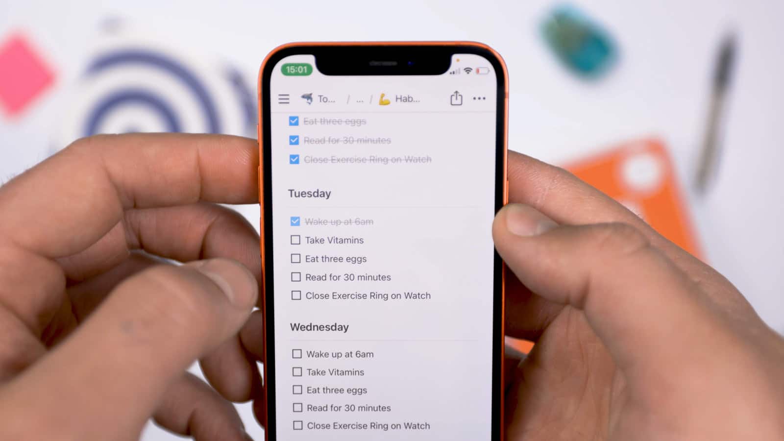 Notion habit tracker app displaying on iPhone in person's hands