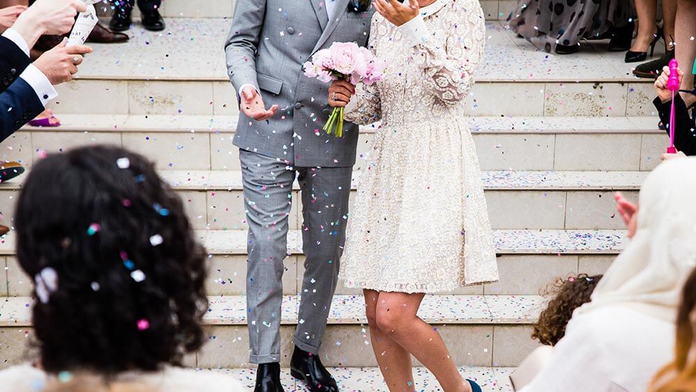 Newly married couple walking down steps