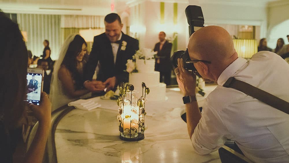 Wedding photographer photographing couple